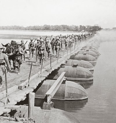 Machine gun section and infantry crossing a flooded river by pontoon bridge by English Photographer
